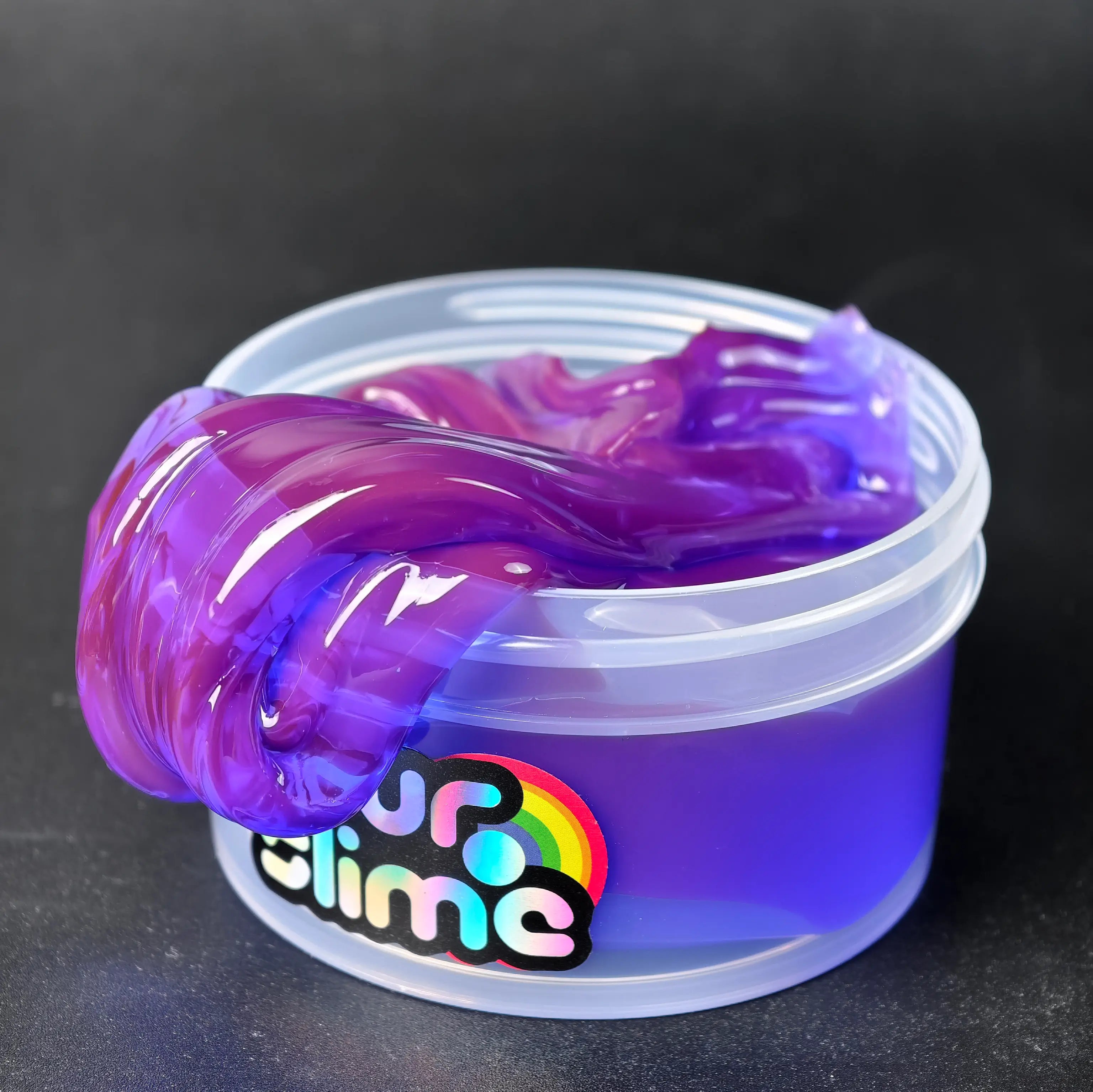 Container of purple and blue slime with a colorful 'slime' label on a black background